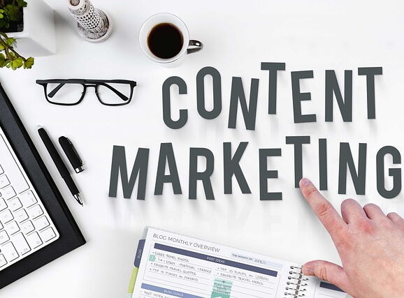 Eine Hand deutet auf den Schriftzug Content Marketing.